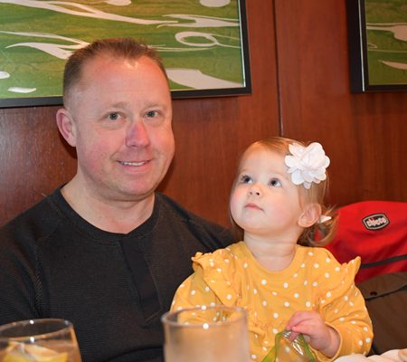 a person and a child sitting at a table