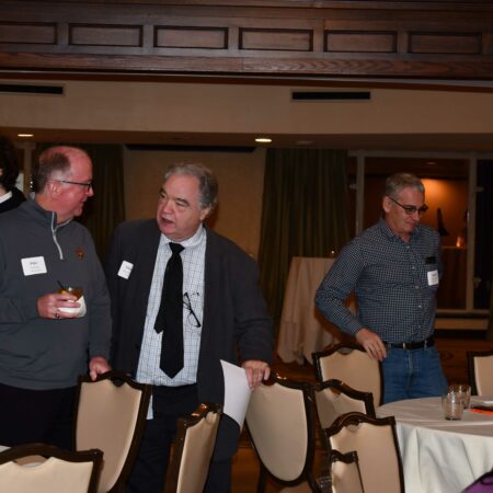 a group of men talking in a room