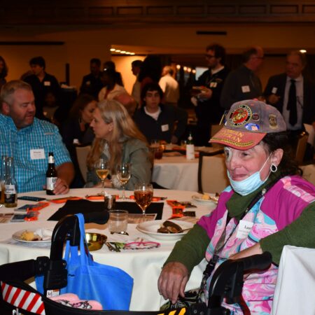 a person sitting at a table with a mask on
