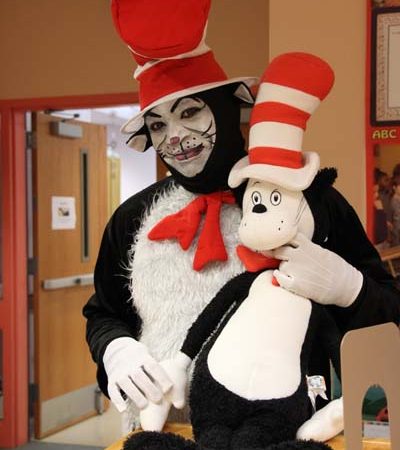a person in garment holding a stuffed animal