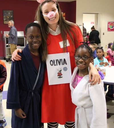 a person with a sign and two children