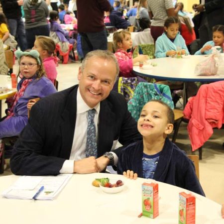a person and child sitting at a table