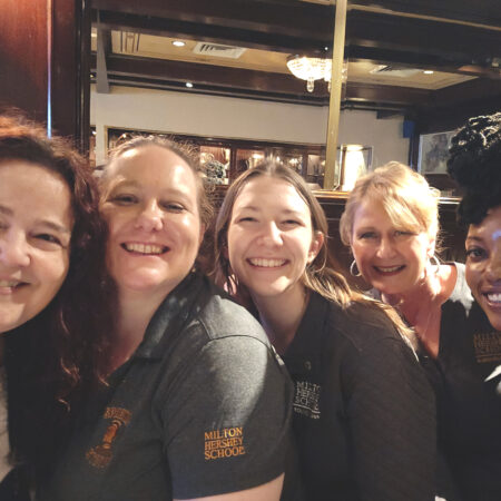a group of women smiling for a photo