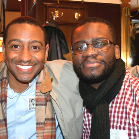 a couple of men smiling