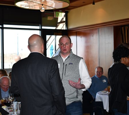 a group of men talking in a restaurant