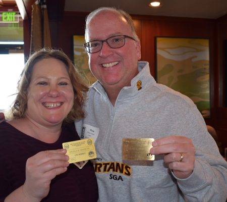 people holding up gold cards
