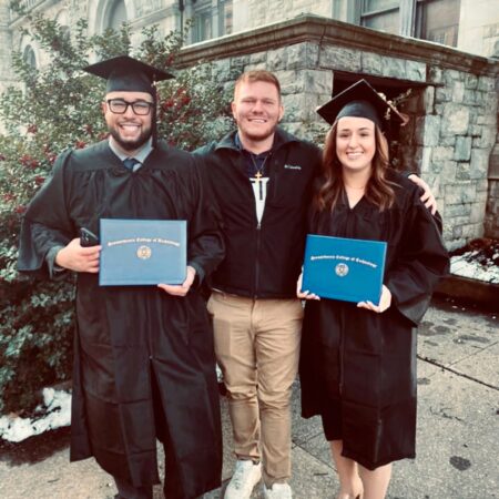 a group of people in graduation gowns and caps