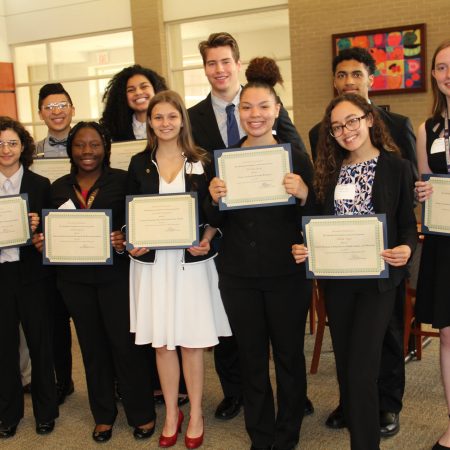 a group of people holding certificates