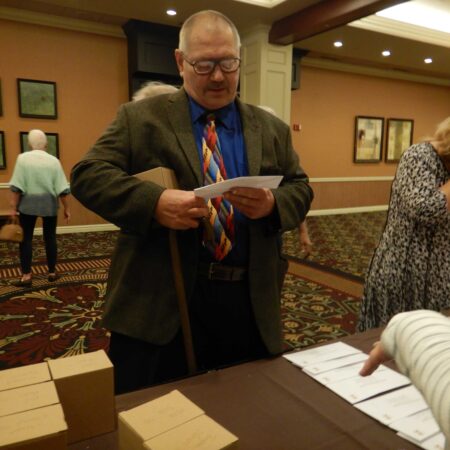 a person standing at a table with papers