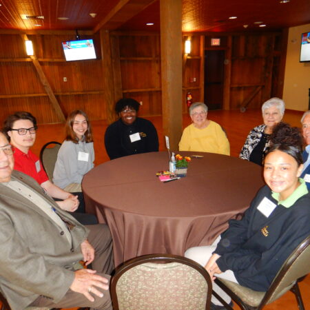 a group of people sitting around a round table
