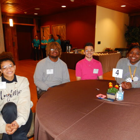 a group of people sitting at a round table