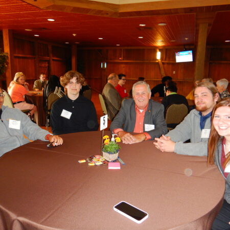 a group of people sitting at a round table