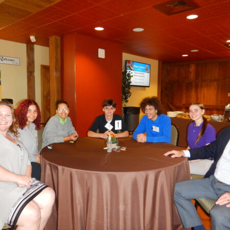 a group of people sitting at a round table