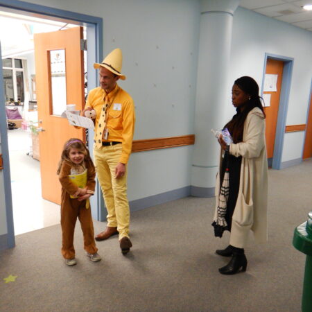 a person and a child standing in a hallway