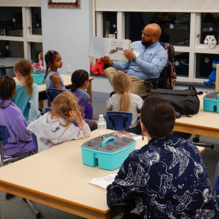 a person reading to a group of children