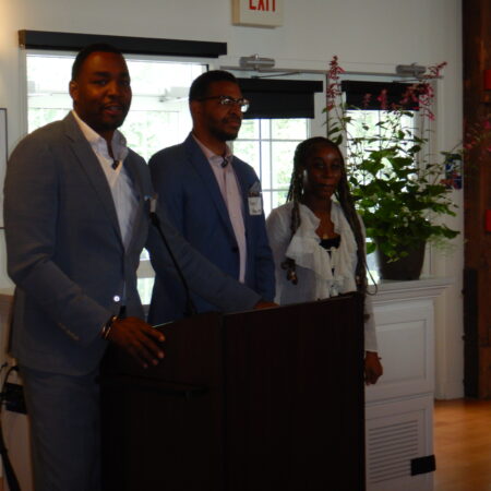 a group of people standing at a podium