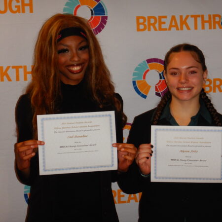 a couple of women holding certificates