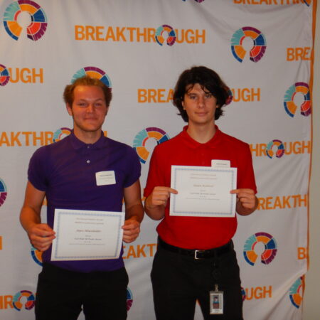 a couple of men holding certificates