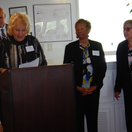 a group of women standing at a podium