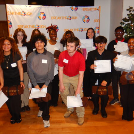 a group of people holding papers