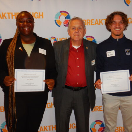 a group of people holding certificates