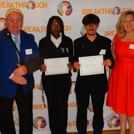 a group of people holding certificates