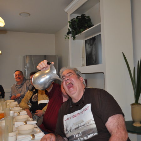a person pouring liquid into a silver pot