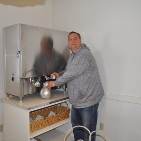 a person pouring coffee into a machine