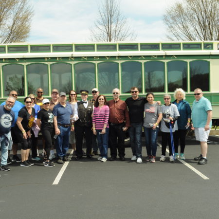 a group of people standing in a parking lot