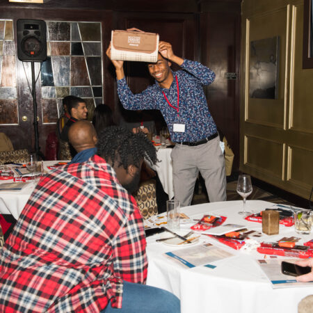 a person holding a box above a table