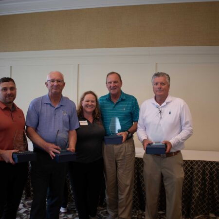 a group of people holding awards