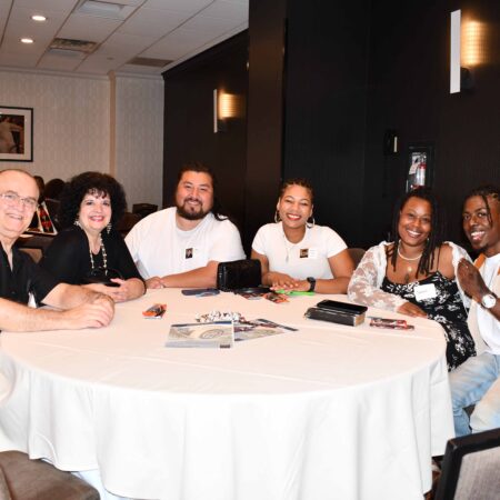a group of people sitting at a round table