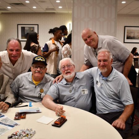 a group of men sitting at a table
