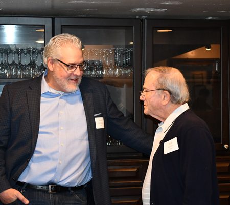 two men standing in a room