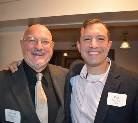 a couple of men smiling