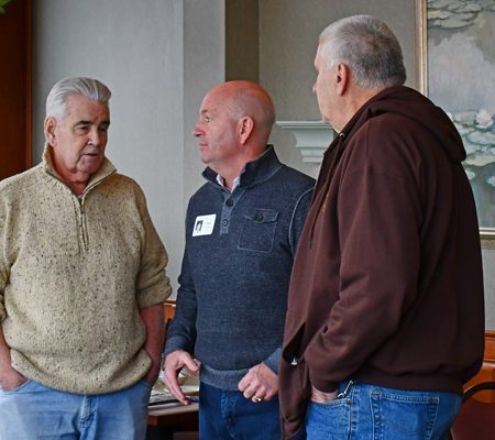 a group of men standing in a room