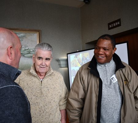 a group of men standing in a room