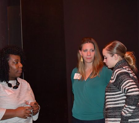 a group of women standing in a room