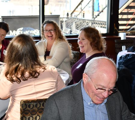 a group of people sitting at tables