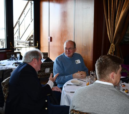 a group of men sitting at a table