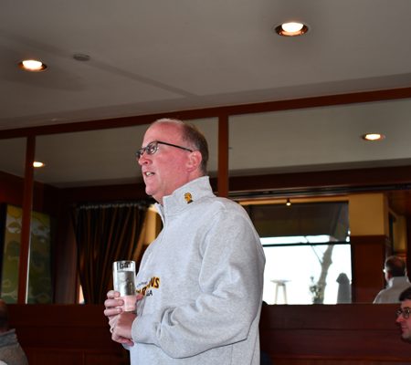 a person in a military uniform holding a glass