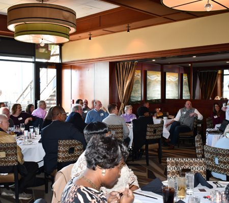 a group of people sitting at tables