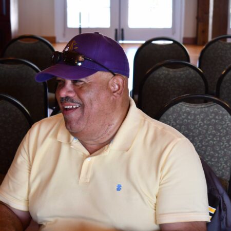 a person wearing a purple hat and sunglasses