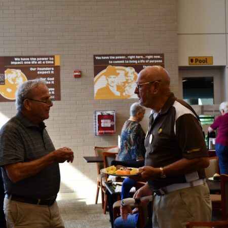 a group of men talking to each other