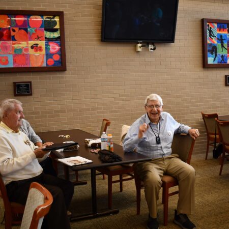 a group of men sitting at a table