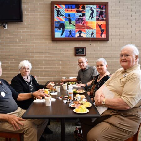 a group of old people sitting at a table