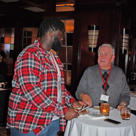 a person talking to another person at a table