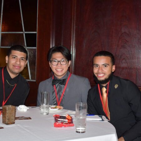 a group of men sitting at a table