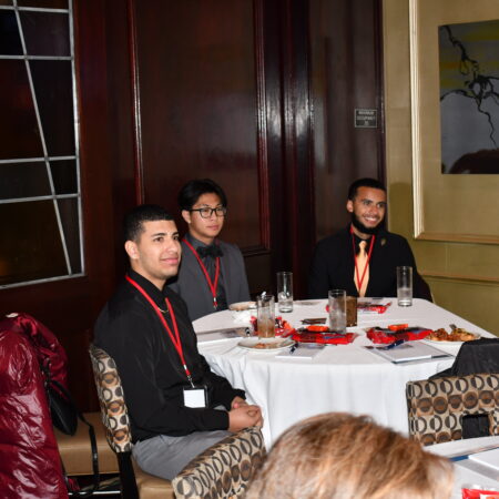 a group of men sitting at a table