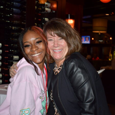 two women smiling at the camera